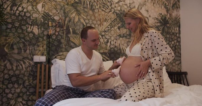 Husband stroking belly of pregnant wife. young parents expecting a baby