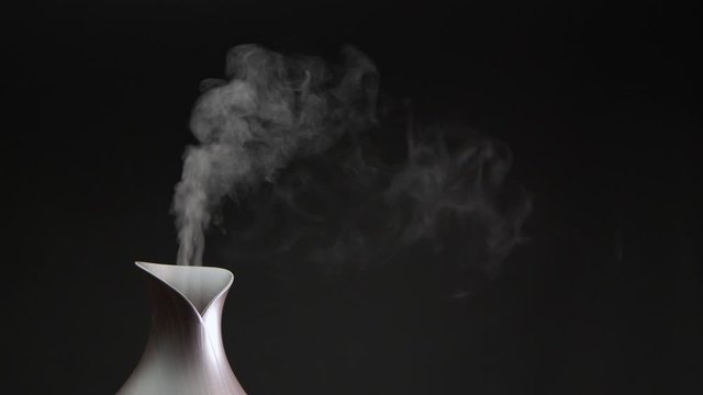 Cool mist machine in studio with a clear black background and room for copy.