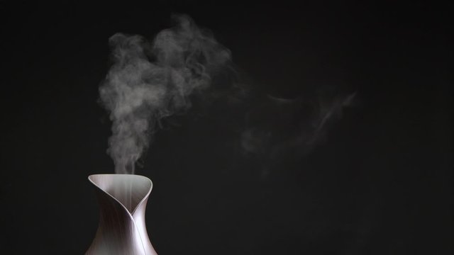 Cool mist machine in studio with a clear black background and room for copy.