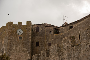 Old walls of Capalbio town under cloudy sky. Grosseto, Tuscany, Italy. 