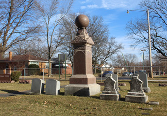 Obelisk surrounded by smaller gravestones at a small suburban Chicago cemetery