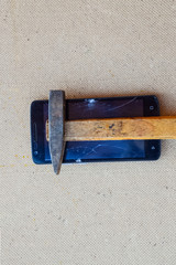 Hammer and smartphone. The screen of the smartphone, a broken ha