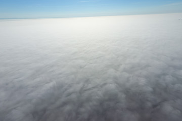 In the skies above the fog. Sunrise over the fog. Clouds near th
