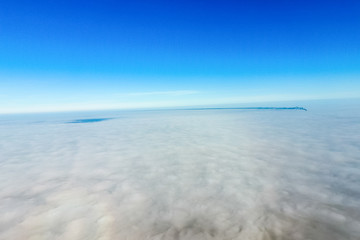 In the skies above the fog. Sunrise over the fog. Clouds near th