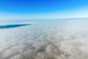 In the skies above the fog. Sunrise over the fog. Clouds near th