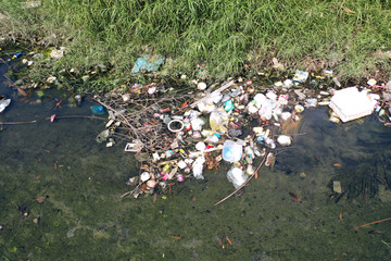 Water pollution. Raw sewage and plastic trash dumped in stream in poor slum village 