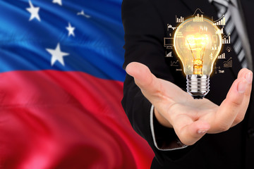 Samoa creativity concept. Businessman with a light bulb in his hand on national background. Innovation and technology theme.