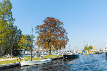 Landscape with waterways and canals of North Holland with boats, canal-side lifestyle in the...