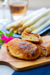 Pastry with bacon and white asparagus vegetables ready to eat served in spring garden