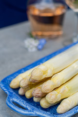 Fresh raw peeled white asparagus vegetables ready to cook and rose wine