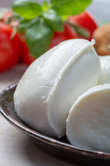 Balls and pieces of buffalo mozzarella, soft Italian scheese made from the milk of Italian Mediterranean buffalo