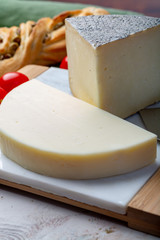 Italian cheeses, mature Tuscan Pecorino sheep cheese and Provolone dolce cow cheese served with olive bread and tomatoes