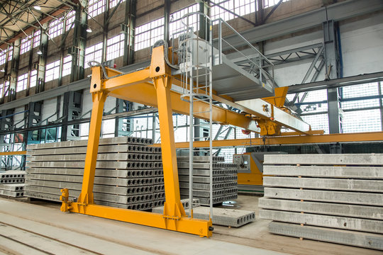 automated equipment for the production line for the production of hollow floor slabs, an overhead crane and folded new slabs.