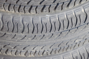 The background of the tread pattern of the car wheel. Rubber tir