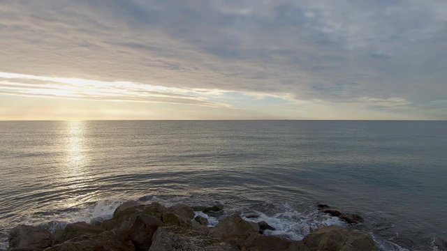 Footage of sea waves splashing on the shore in Sitges, Spain.
