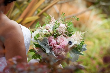 bride holding the wedding bouquet of flowers