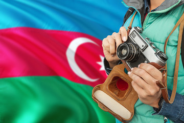 Azerbaijan photographer concept. Close-up adult woman holding retro camera on national flag background. Adventure and traveler theme.