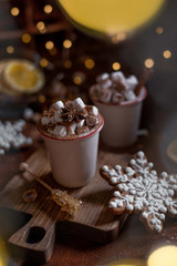 Marshmallow coffee in ceramic mugs on a concrete brown background