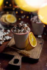 Cup of hot chocolate, marshmallow, cinnamon sticks and gingerbread close up.