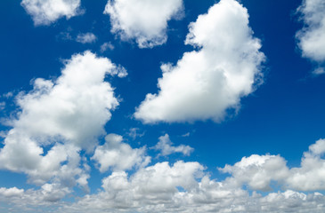Large white clouds scattered in the blue sky. Resource for designers.