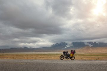 Traveling motorcycle with luggage in stormy weather