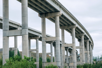 Concrete pillars or trestle under the viaduct or highway bridge