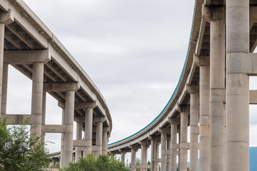 Concrete pillars or trestle under the viaduct or highway bridge