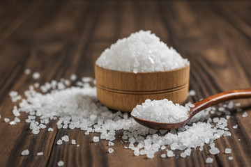 Wooden spoon with coarse salt next to the bowl.