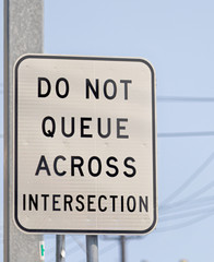 Do not queue across intersection, signposts that cannot cross in the lane.