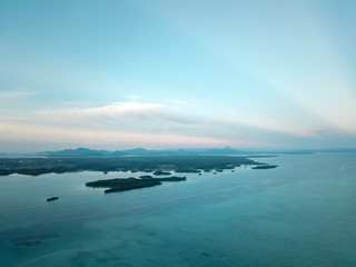 Aerial wide panorama of Bum Bum Island against an early morning blue sky colourful sunrise in...