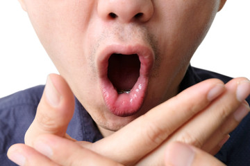Oral health Men use hands to check for bad breath and breathe.
