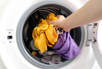 man's hand Pick up clothes Washing machine.Clean and Healthy Concepts