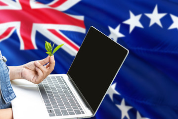 Cook Islands modern agriculture concept. Farmers holding laptop, check tea on national flag background. Ecology theme with copy space.