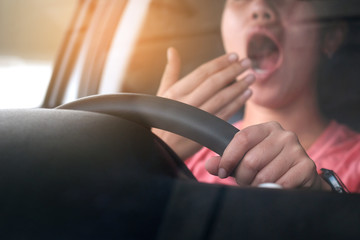 Sleepy woman While she was driving on the road. Concept of health and driving safety