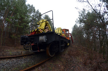 Special railway service train cuts overhanging branches. Near Kiev, Ukraine