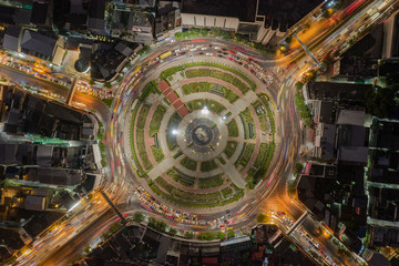Road roundabout with car lots Wongwian Yai in Bangkok,Thailand. street large beautiful downtown at night light. Aerial view , Top view ,cityscape ,Rush hour traffic jam