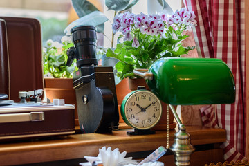 Retro still life with alarm clock, player, camera, table lamp