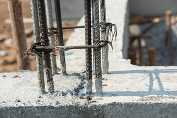 Reinforce iron cage for a house column in a construction site. Steel reinforcing bar for reinforced concrete. A small unit of tie rebar beam cage.