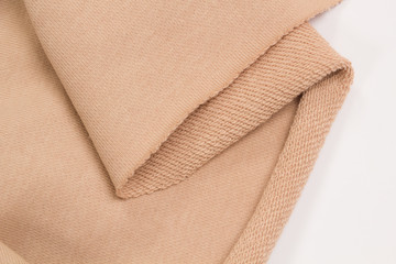 Cotton fabric on white background. Beige textile