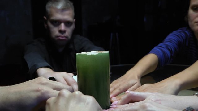 The concept of a spiritualistic session. people hold hands on a moving saucer 