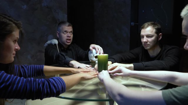 A session of spiritualism. a mage with a white rat on his shoulder casts a spell