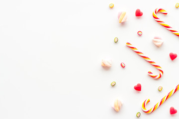 Christmas candies frame on white backgound top-down copy space