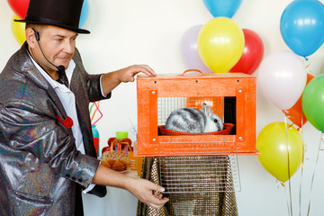 Magician, an illusionist shows tricks.