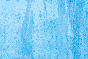 Fototapeta na wymiar Non-uniform blue paint background on metal surface