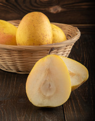 Ripe yellow pears on a wooden table
