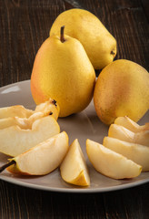 Ripe yellow pears on a wooden table