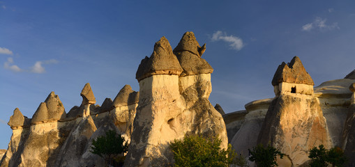 Panorama of Fairy Chimneys in golden light at sunset in Pasabag Monks Valley Cappadocia Turkey
