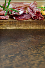 Meat and cheese plate antipasti snack with Prosciutto ham, Parmesan, Blue cheese, Cantaloupe melon and Olives on olive wood serving board with copy space