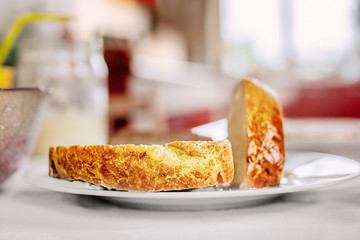 Piece of white bread on a white plate in a blurry background