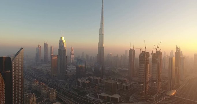 DUBAI, UAE - JANUARY 2, 2017: Aerial view of Burj Khalifa downtown Dubai at sunset. The Burj al Khalifa is the tallest structure in the world, standing at 829.8 m (2,722 ft). Scenic dusk 4K scene.
